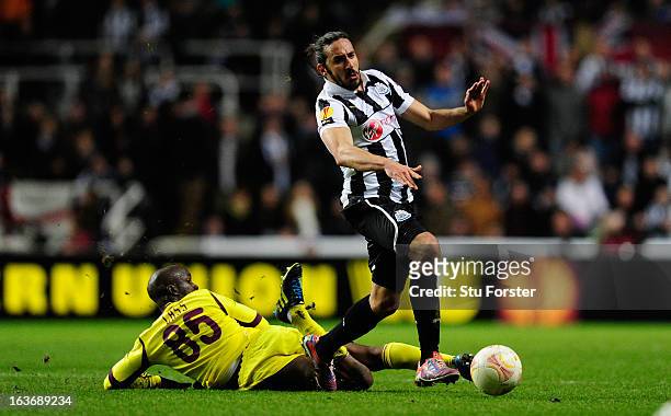 Newcastle player Jonas Gutierrez rides the challenge of Lassana Diarra during the UEFA Europa League Round of 16 second leg match between Newcastle...