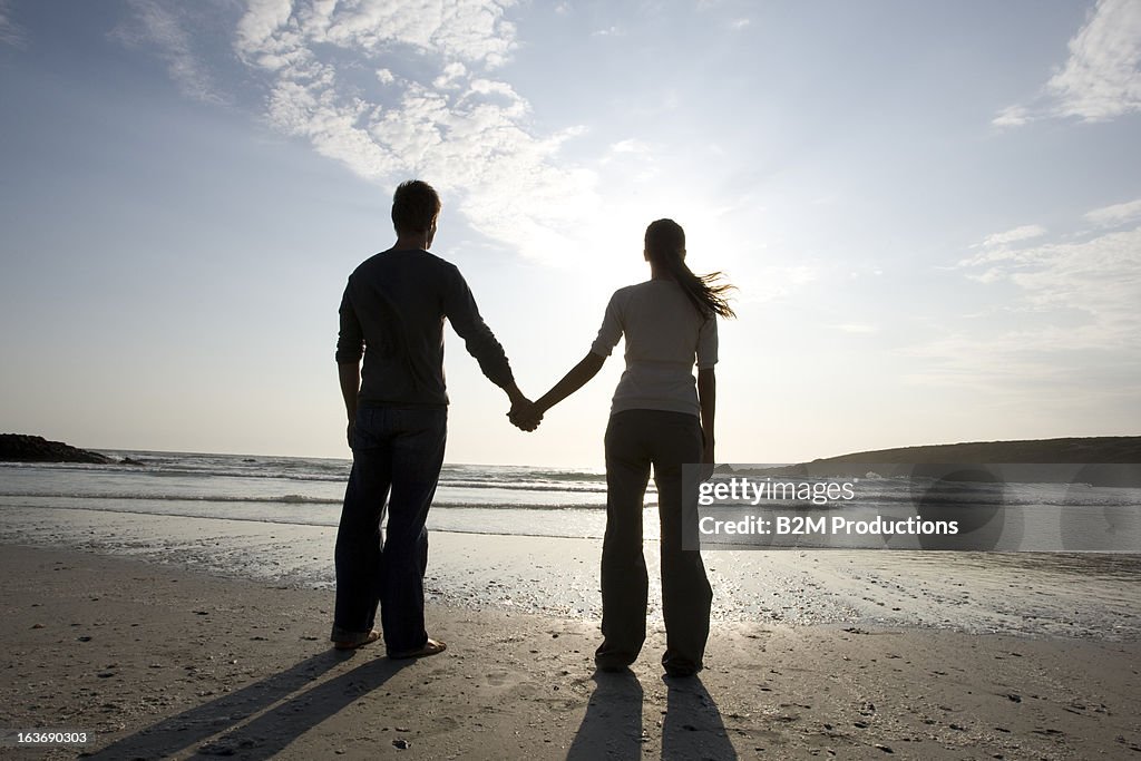 Couple hand in hand on a beach