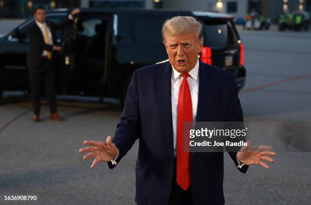 Former U.S. President Donald Trump speaks to the media at Atlanta Hartsfield-Jackson International Airport after being booked at the Fulton County...