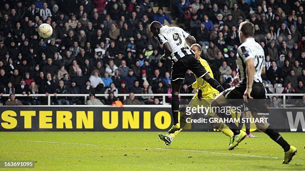 Newcastle United's Senegalese striker, Papiss Cisse scores their first goal during the UEFA Europa League round of 16 second leg match between...