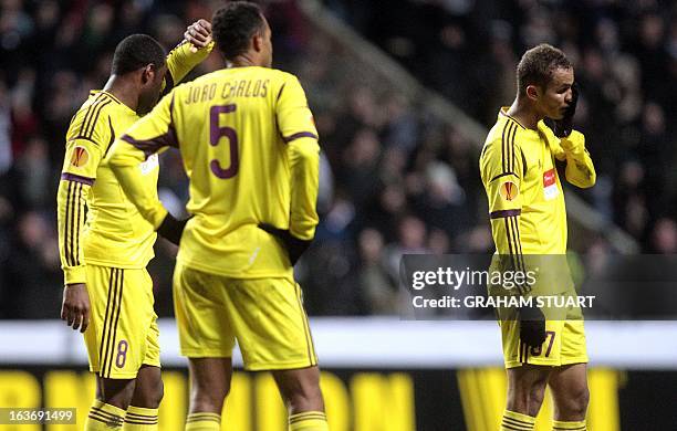 Anzhi Makhachkala's Brazilian midfielder Jucilei , Brazilian defender, Joao Carlos and Brazilian defender, Ewerton look on after losing 1-0 in the...