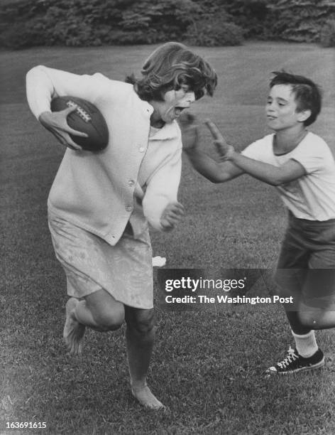 Eunice Shriver plays during a Kennedy family touch football game. Photographed September 26, 1965 at unknown location.