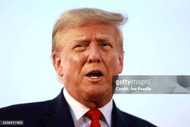 Former U.S. President Donald Trump speaks to the media at Atlanta Hartsfield-Jackson International Airport after being booked at the Fulton County...