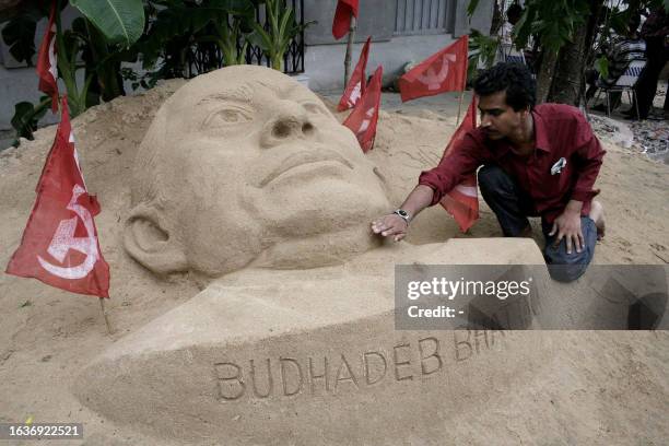 Communist party activist Swapan Das gives the finishing touch to a sand sculpture of Buddhadev Bhattacharya, the chief Minister of India's eastern...