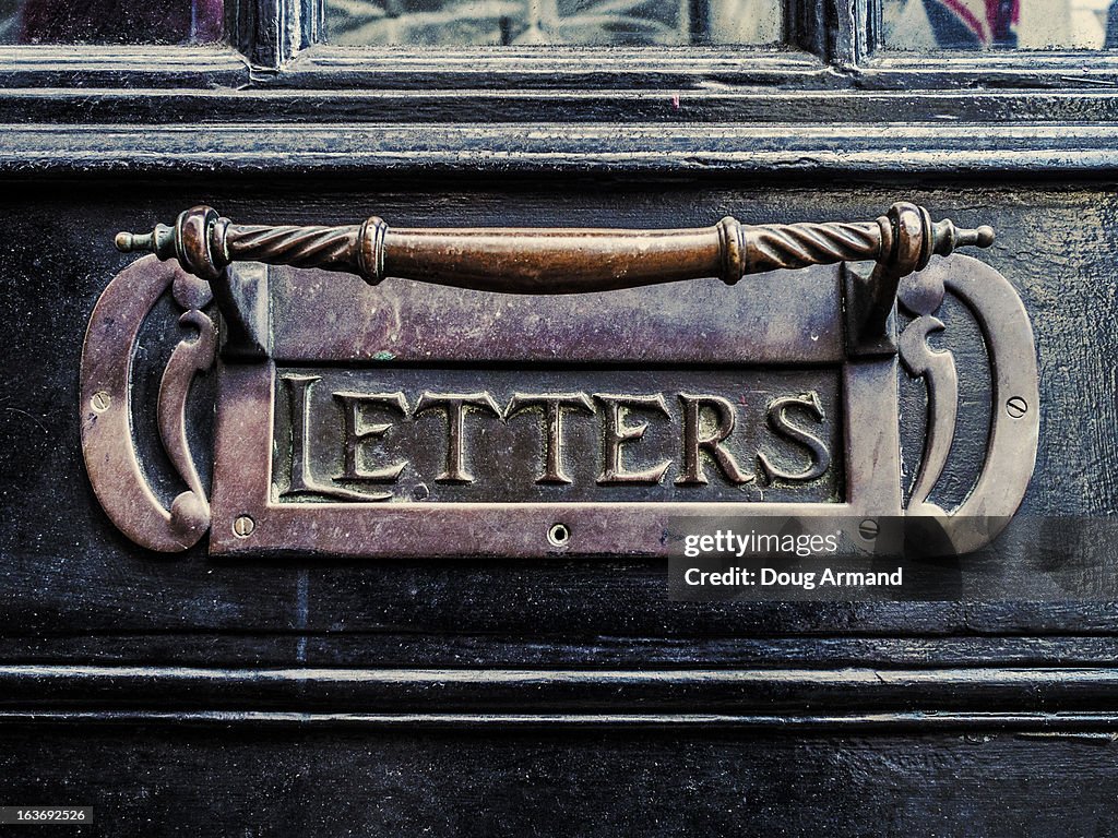 Old metal door letterbox