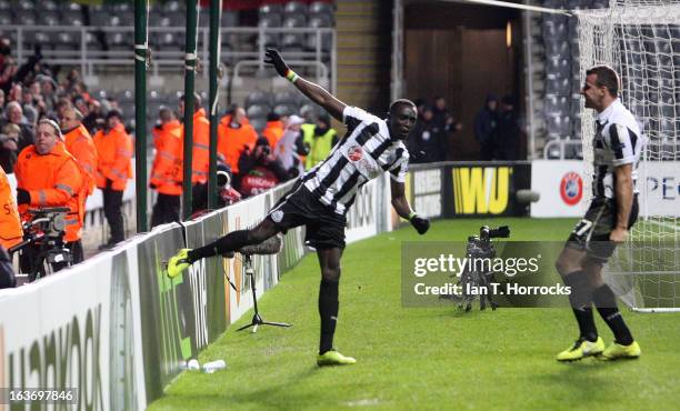 Papis Cisse of Newcastle United celebrates with Steven Taylor after scoring the only goal during the UEFA Europa League Round of 16 second leg match...