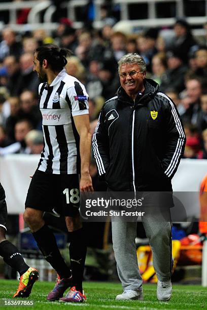 Anji manager Guus Hiddink shares a joke with Jonas Gutierrez during the UEFA Europa League Round of 16 second leg match between Newcastle United FC...