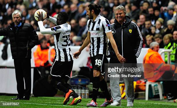 Anji manager Guus Hiddink shares a joke with Jonas Gutierrez during the UEFA Europa League Round of 16 second leg match between Newcastle United FC...