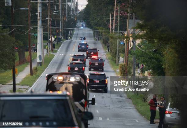 Former U.S. President Donald Trump rides in a motorcade as he travels to the Fulton County jail on August 24, 2023 in Atlanta, Georgia. Trump...