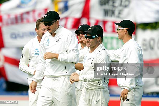 Peter Fulton of New Zealand is congratulated by teammate Brendon McCullum after taking a catch to dismiss Ian Bell of England during day two of the...