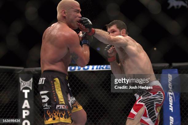 Forrest Griffin punches Tito Ortiz during their light heavyweight bout at UFC 148 inside MGM Grand Garden Arena on July 7, 2012 in Las Vegas, Nevada.