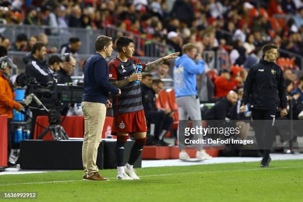 Head coach Terry Dunfield of Toronto FC speaks with Franco Ibarra of Toronto FC during the MLS Major League Soccer match between Toronto FC and...