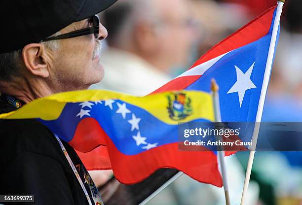 Fan is seen with the national flags of Puerto Rico and Venezuela in the stands during Pool C, Game 5 between Spain and Venezuela in the first round...