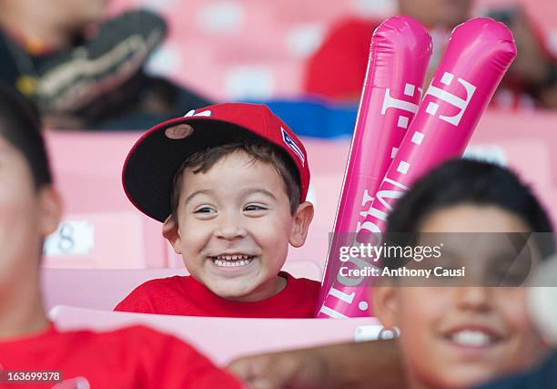 Young fan smiles as he watches the game from the stands during Pool C, Game 5 between Spain and Venezuela in the first round of the 2013 World...