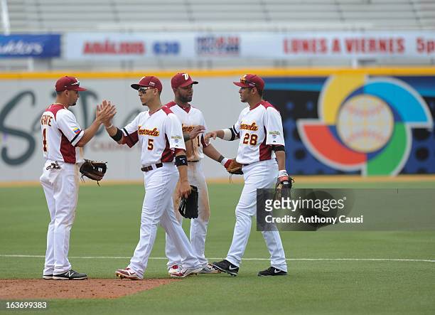 Members of Team Venezuela celebrate defeating Team Spain in Pool C, Game 5 in the first round of the 2013 World Baseball Classic at Hiram Bithorn...