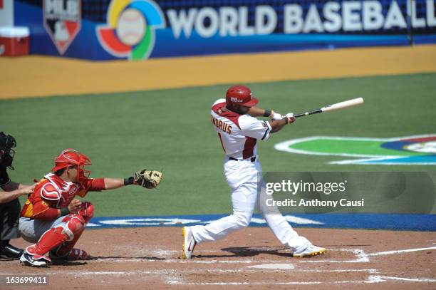 Elvis Andrus of Team Venezuela hits an RBI single in the bottom of the fourth inning during Pool C, Game 5 against Spain in the first round of the...