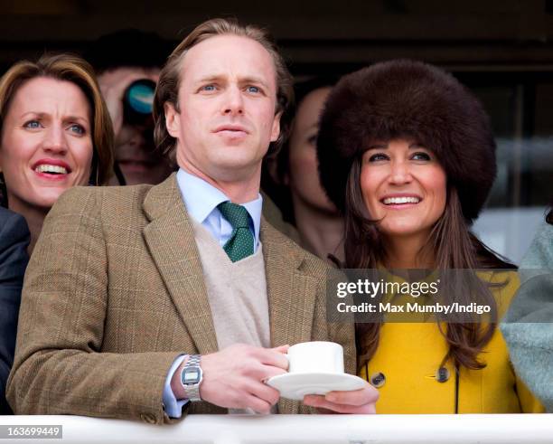 Tom Kingston and Pippa Middleton watch the racing as they attend Day 3 of The Cheltenham Festival at Cheltenham Racecourse on March 14, 2013 in...