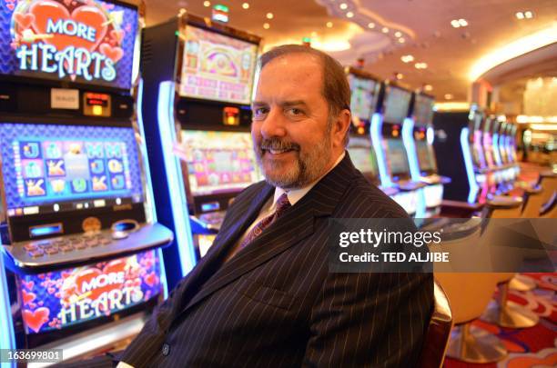 Michael French, chief operating officer of Solaire Resorts and casino, poses for photo next to gaming machines inside the casino in Manila on March...