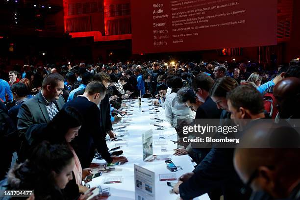 Attendees view the Samsung Electronics Co. Galaxy S4 smartphone during an event at Radio City Music Hall in New York, U.S., on Thursday, March 14,...