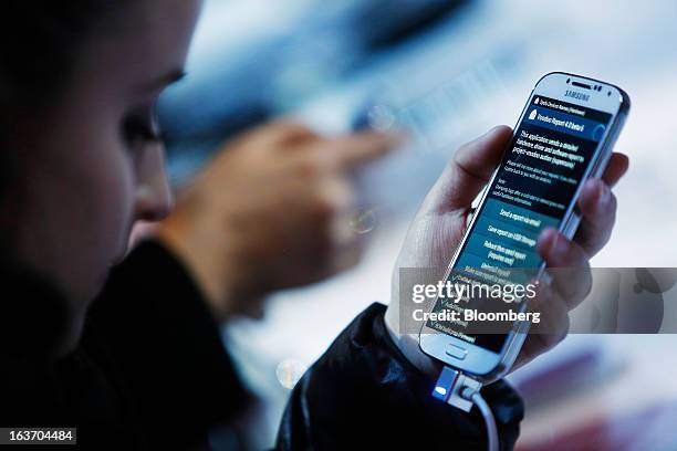 Attendees view the Samsung Electronics Co. Galaxy S4 smartphone during an event at Radio City Music Hall in New York, U.S., on Thursday, March 14,...