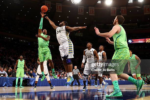 Eric Atkins of the Notre Dame Fighting Irish drives for a shot attempt against Davante Gardner of the Marquette Golden Eagles during the quaterfinals...