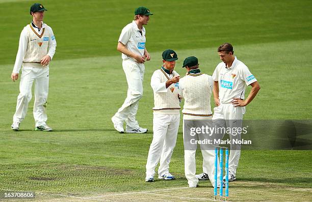 Ricky Ponting, George Bailey and Luke Butterworth of Tasmania discuss field placings during day two of the Sheffield Shield match between the...