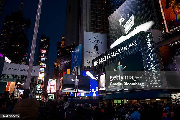 Shin, head of Samsung Electronics Co.'s mobile division, is displayed on screens as spectators gather at the release of the Samsung Electronics Co....