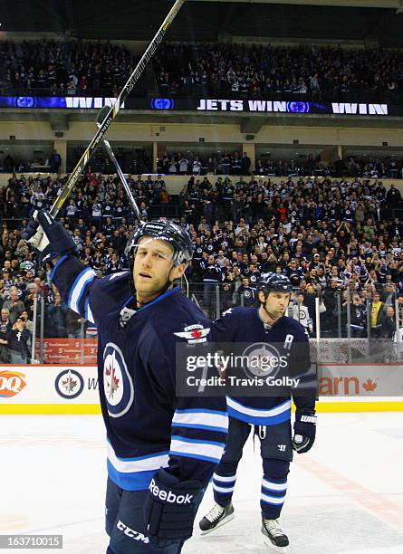 Derek Meech and Mark Stuart of the Winnipeg Jets raise their sticks in a salute to home fans following a 3-1 victory over the New York Rangers at the...