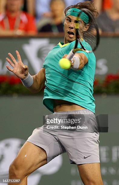 Rafael Nadal of Spain hits a return to Roger Federer of Switzerland during day 9 of the BNP Paribas Open at Indian Wells Tennis Garden on March 14,...