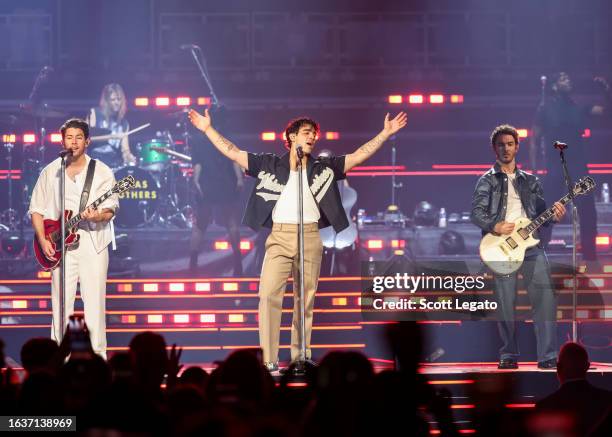Nick Jonas, Joe Jonas and Kevin Jonas perform onstage during Jonas Brothers “Five Albums, One Night” Tour at Little Caesars Arena on August 24, 2023...