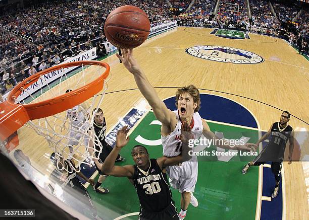 Jake Layman of the Maryland Terrapins jumps over Travis McKie of the Wake Forest Demon Deacons during the first round of the Men's ACC Basketball...