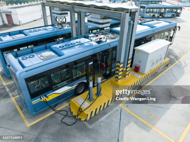 electric bus being recharged - green technology stock pictures, royalty-free photos & images