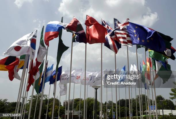 The flags of participating countries wave outside the Bharat Mandapam at ITPO Convention Centre ahead of the G20 India Summit in New Delhi, India on...