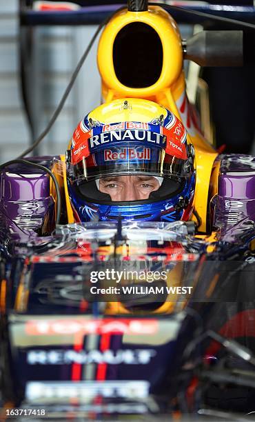 Red Bull driver Mark Webber of Australia sits in his cockpit during the first practice session for the Formula One Australian Grand Prix in Melbourne...