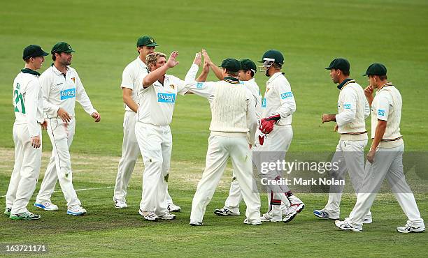Mark Cosgrove of Tasmania celebrates a wicket with team mates during day two of the Sheffield Shield match between the Tasmania Tigers and the...