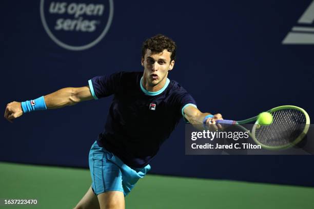 Juan Manuel Cerundolo of Argentina returns a shot to Borna Coric of Croatia during their quarterfinals match of the Winston-Salem Open at Wake Forest...