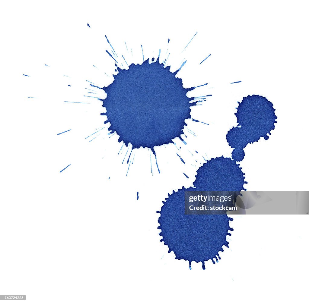 Isolated blue ink splatter drops close-up