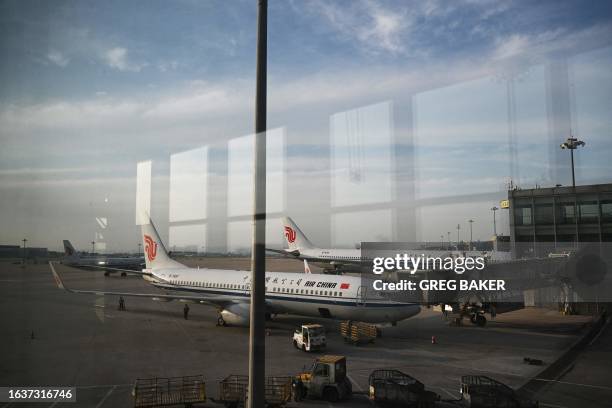 Air China aircraft are seen from a boarding gate in the domestic terminal of Beijing Capital Airport in Beijing on September 1, 2023.