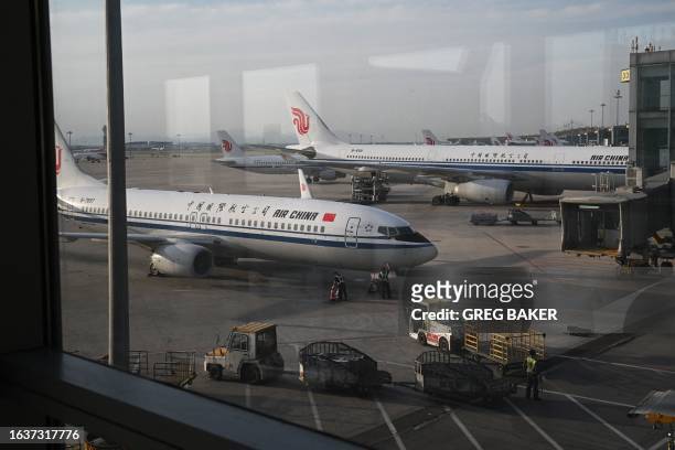 Air China aircraft are seen from a boarding gate in the domestic terminal of Beijing Capital Airport in Beijing on September 1, 2023.