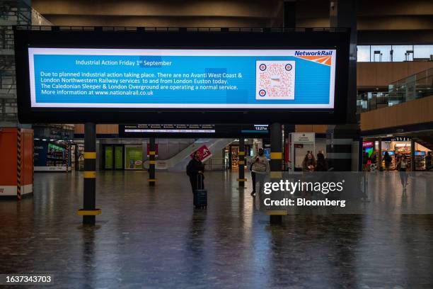 Notice informs passengers of train drivers strike action on a near-empty concourse at Euston railway station in London, UK, on Friday, Sept. 1, 2023....