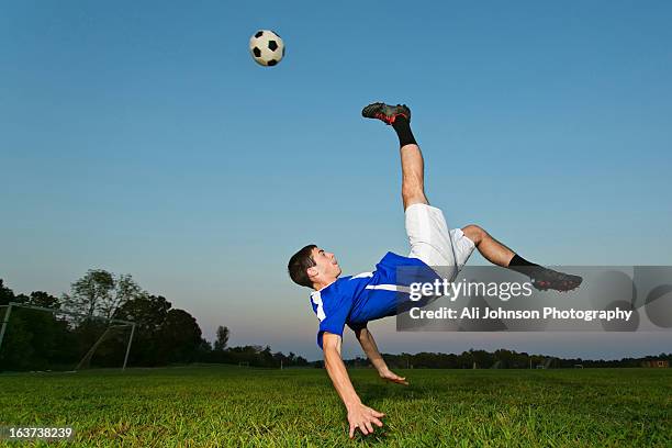 teenage soccer player kicks the ball - bicycle kick stock pictures, royalty-free photos & images