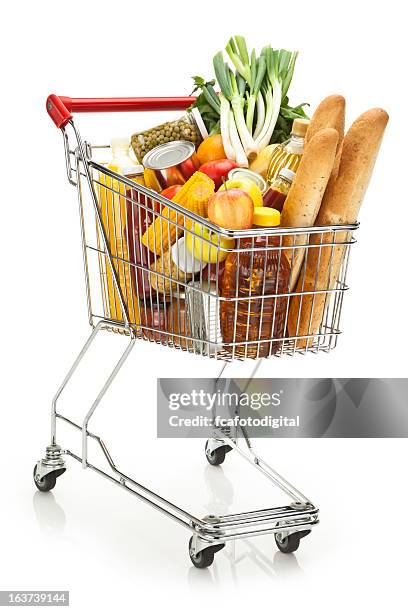 shopping cart filled with variety of groceries on white backdrop - shopping trolleys stockfoto's en -beelden