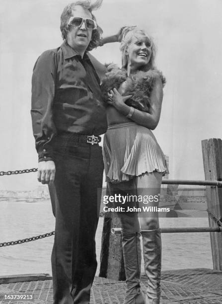 English adult magazine publisher and strip club owner Paul Raymond with his girlfriend, actress Fiona Richmond, Brighton, 1972. Richmond is playing...