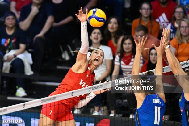 Turkey's Hande Baladin spikes the ball past Italy's Anna Danesi during the 2023 Women's EuroVolley quarter final volleyball match between Italy and...