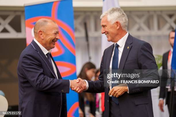 Australia's head coach Eddie Jones shakes hands with former Welsh rugby player and former chairman of the Welsh Rugby Union, Gareth Davies, during a...