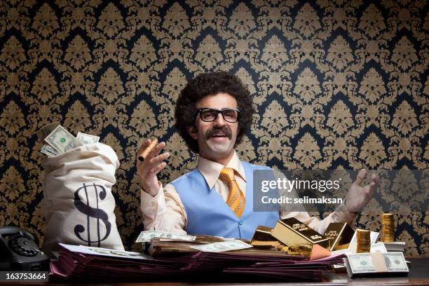 rich man posing with money bags, gold bullions, dollar bills - welvaart stockfoto's en -beelden