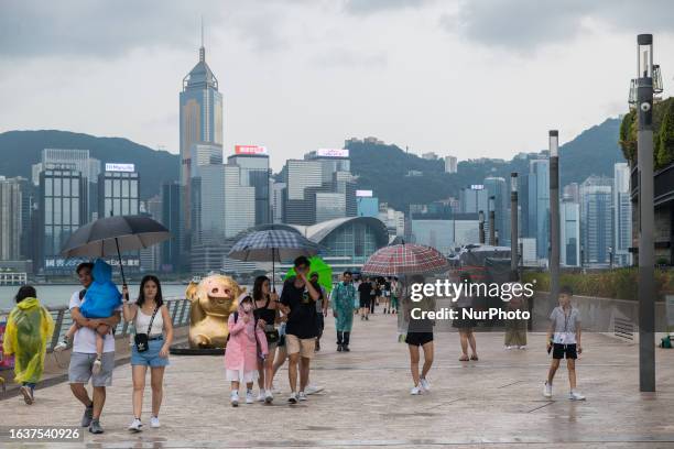 Families with children can be seen walking on the Avenue of Stars in Hong Kong, China, on September 1 despite the alert level being at number 8.