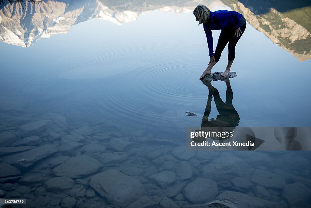 Reflection of woman doing stretching exercises, mt