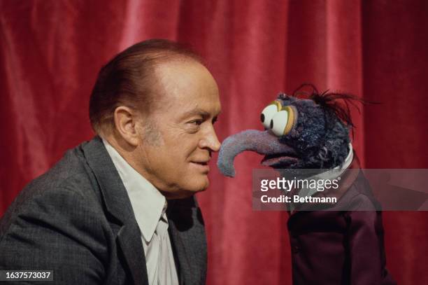 American comedian and actor Bob Hope pictured nose to nose with Gonzo the Muppet at Elstree Studios in London, December 5th 1977.