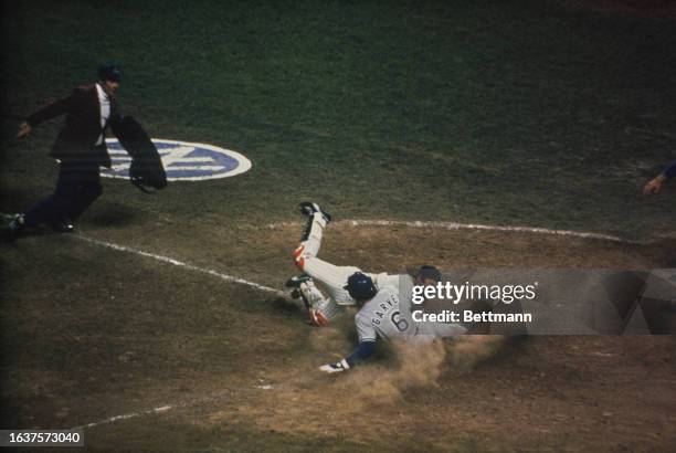 Thurman Munson of the New York Yankees tags the Los Angeles Dodgers' Steve Garvey at the plate in the 6th inning of the World Series opener in New...